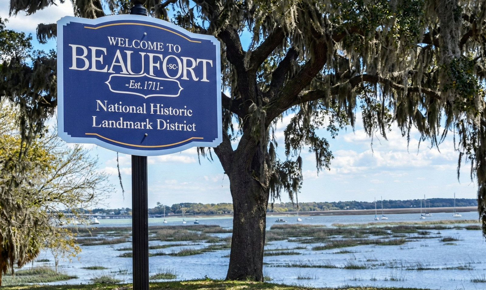Welcome to Beaufort SC - National Historic Landmark District sign with Spanish moss and waterfront